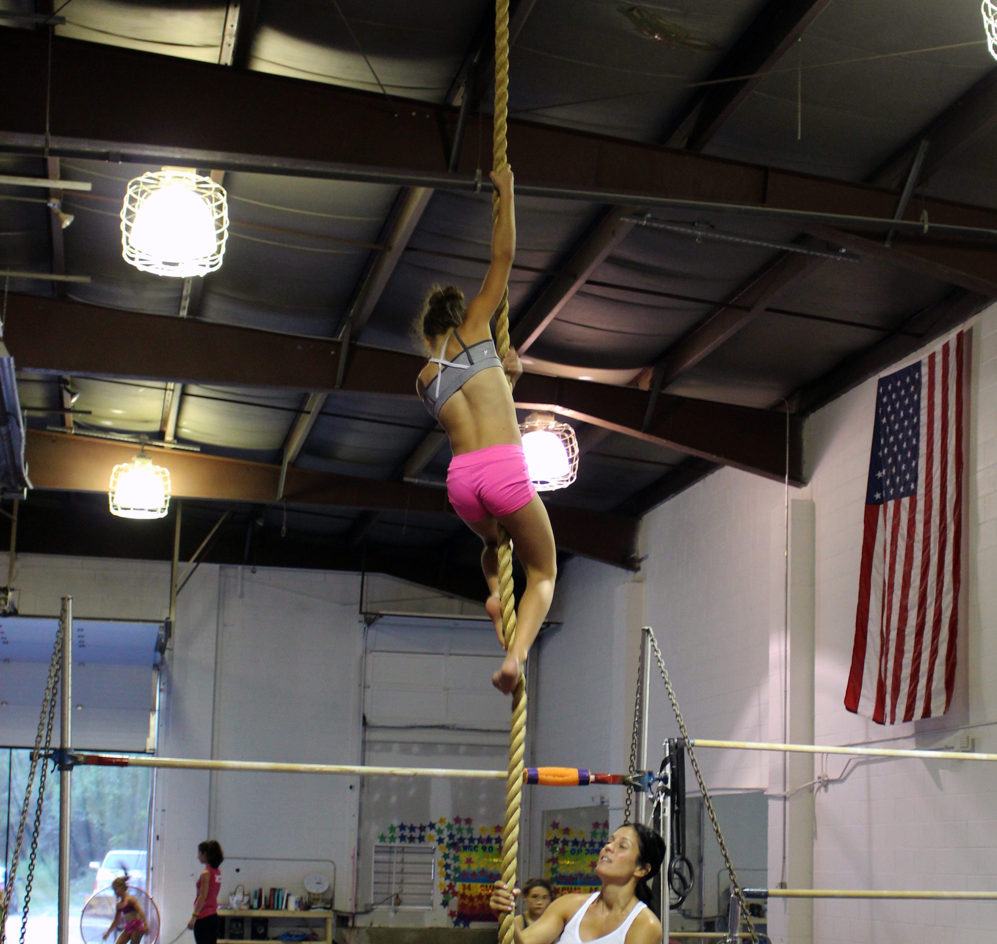 Smiling girl climbing on rope acrobatic gymnastic girl exercising on fabric  rope Stock Photo - Alamy